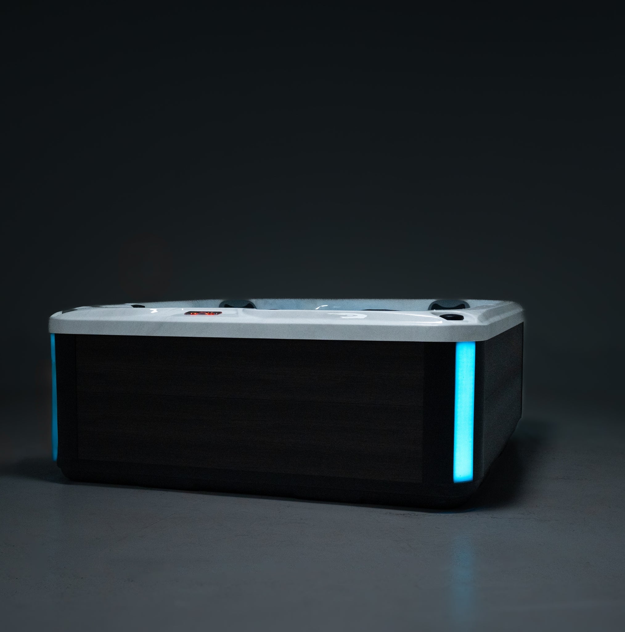 Outdoor Whirlpool PureLine Balance 28 mit LED-Beleuchtung, grauer Verkleidung, Wasserfläche und modernem Design für Garten und Wellness.